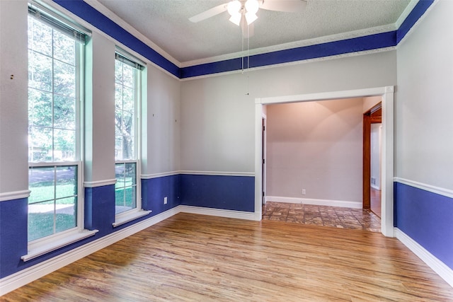 5008 Natchez Dr, Sachse, TX 75048 - empty room with wood finished floors, ceiling fan, and a textured ceiling