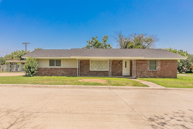 5909 Eisenhower Dr, Fort Worth, TX 76112 - single story home featuring brick siding, concrete driveway, and a front lawn