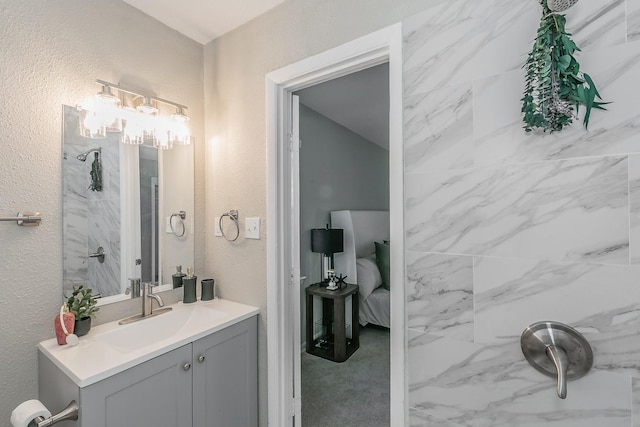 5909 Eisenhower Dr, Fort Worth, TX 76112 - bathroom featuring vanity, a textured wall, and ensuite bath
