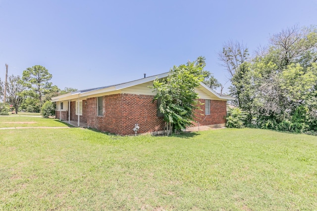 5909 Eisenhower Dr, Fort Worth, TX 76112 - view of home's exterior featuring brick siding and a yard