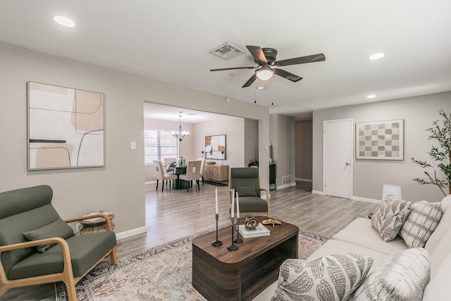 5909 Eisenhower Dr, Fort Worth, TX 76112 - living room featuring ceiling fan, a chandelier, light wood-style flooring, and recessed lighting