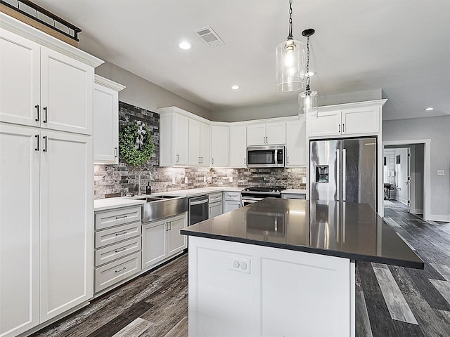 403 Sonoma Ct, Sherman, TX 75092 - kitchen featuring appliances with stainless steel finishes, dark wood-style flooring, recessed lighting, decorative backsplash, and white cabinets