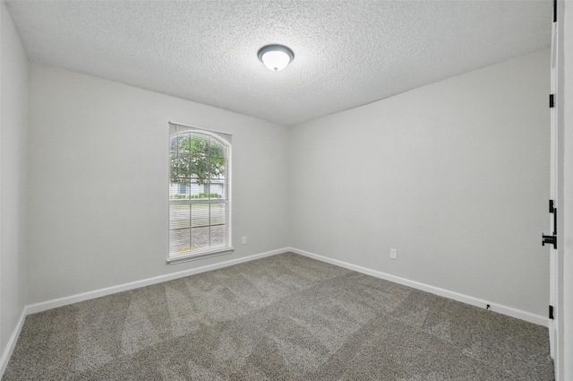 633 S Waxahachie St, Mansfield, TX 76063 - spare room featuring carpet flooring and a textured ceiling
