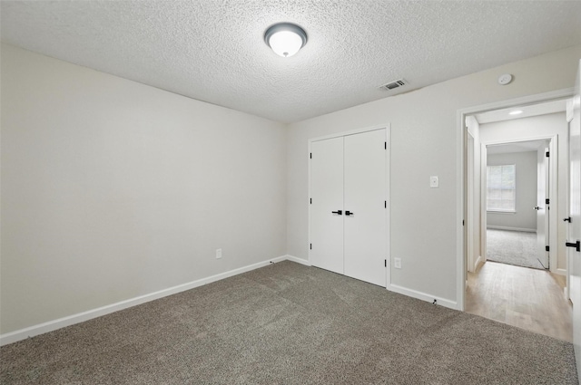 633 S Waxahachie St, Mansfield, TX 76063 - unfurnished bedroom featuring carpet, a textured ceiling, and a closet