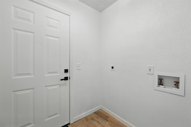 633 S Waxahachie St, Mansfield, TX 76063 - laundry room featuring hookup for a washing machine, light wood-style floors, electric dryer hookup, and a textured ceiling