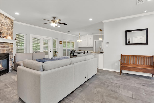 2104 Turtlecreek, Denison, TX 75020 - living room featuring crown molding, ceiling fan, a fireplace, and recessed lighting