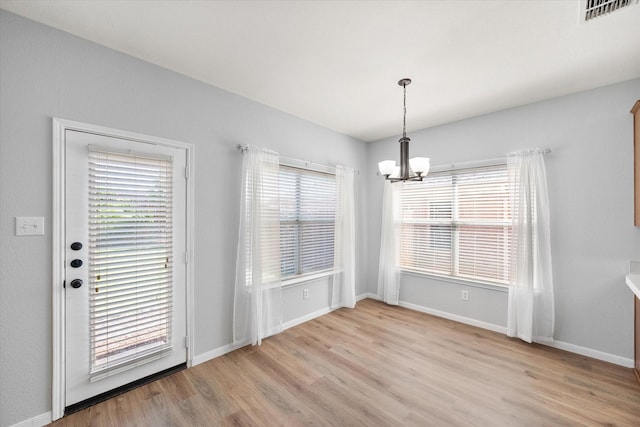 1205 Bonnet Dr, Fort Worth, TX 76131 - unfurnished dining area featuring a chandelier and light wood finished floors
