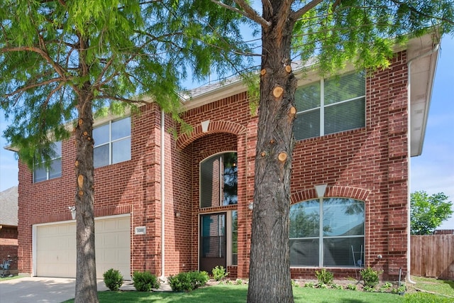 1205 Bonnet Dr, Fort Worth, TX 76131 - view of front facade with an attached garage, brick siding, and driveway