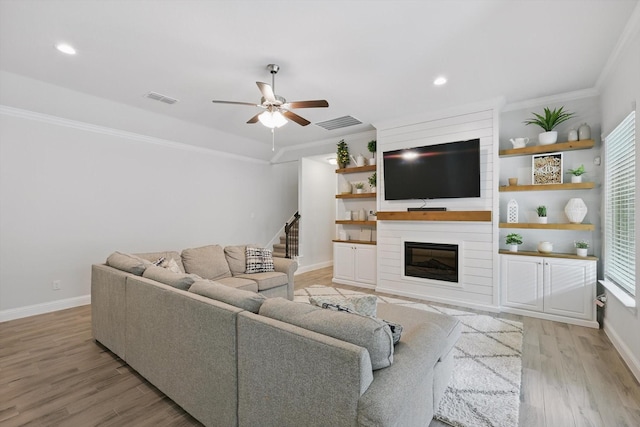 824 10th St, Argyle, TX 76226 - living area featuring light wood-style floors, crown molding, ceiling fan, a large fireplace, and recessed lighting