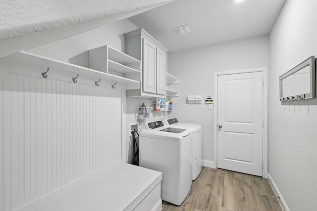 824 10th St, Argyle, TX 76226 - laundry room featuring cabinet space, washing machine and dryer, and light wood-type flooring