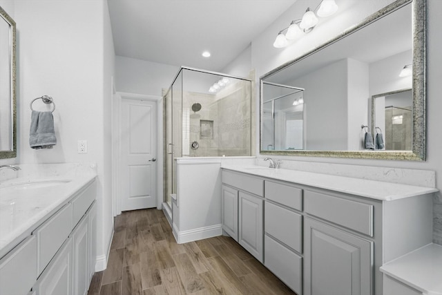 824 10th St, Argyle, TX 76226 - full bathroom featuring a stall shower, two vanities, and wood finished floors