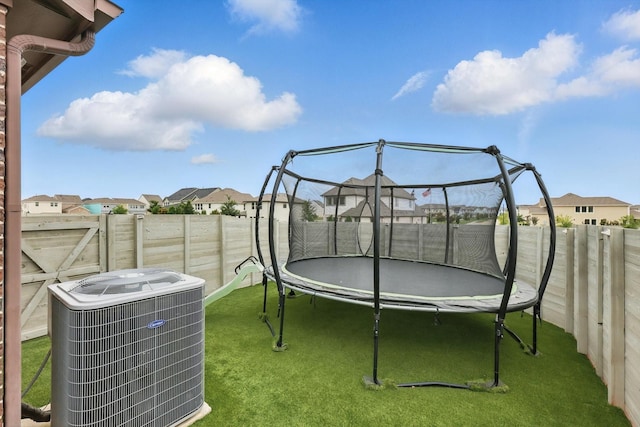 824 10th St, Argyle, TX 76226 - fenced backyard featuring a trampoline and a residential view
