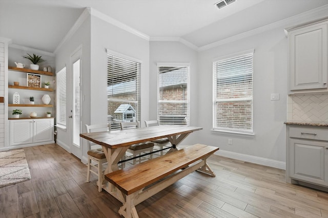 824 10th St, Argyle, TX 76226 - dining space featuring ornamental molding, light wood-style flooring, and lofted ceiling