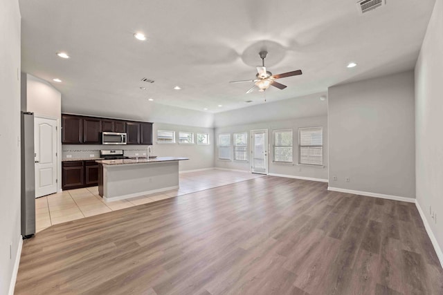 1033 Water Garden Cir, Little Elm, TX 75068 - unfurnished living room featuring recessed lighting, a ceiling fan, and light wood finished floors