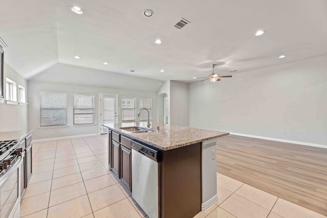 1033 Water Garden Cir, Little Elm, TX 75068 - kitchen featuring stainless steel appliances, ceiling fan, light tile patterned flooring, open floor plan, and a center island with sink