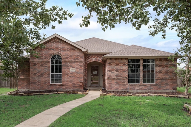 104 Singleton Dr, Royse City, TX 75189 - view of front of home with brick siding, roof with shingles, and a front yard