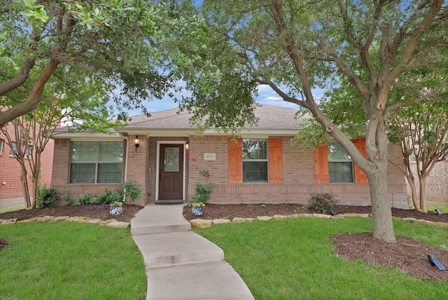 4517 Evanshire Way, Mckinney, TX 75070 - view of front of home featuring brick siding, a front lawn, and a shingled roof