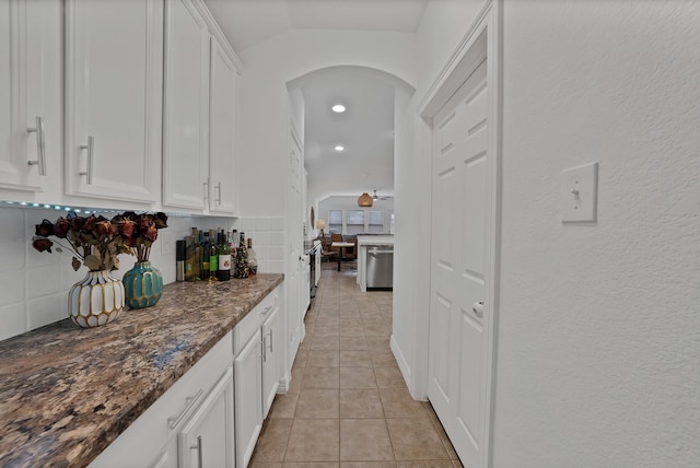 4517 Evanshire Way, Mckinney, TX 75070 - kitchen featuring dishwasher, arched walkways, tasteful backsplash, white cabinets, and light tile patterned floors
