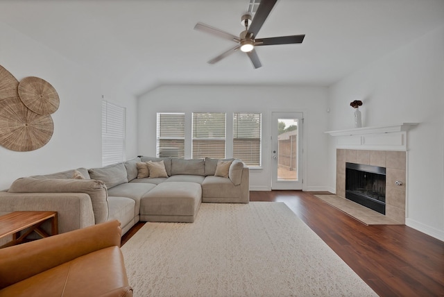 4517 Evanshire Way, Mckinney, TX 75070 - living area with dark wood finished floors, a ceiling fan, a tile fireplace, and lofted ceiling