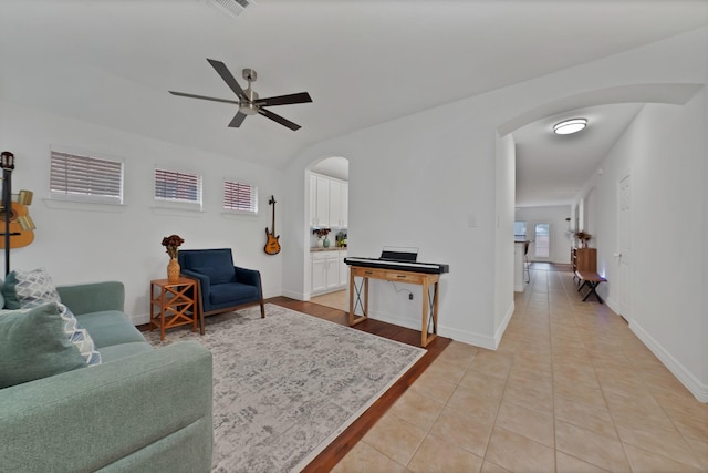 4517 Evanshire Way, Mckinney, TX 75070 - living room with arched walkways, ceiling fan, light tile patterned floors, and lofted ceiling