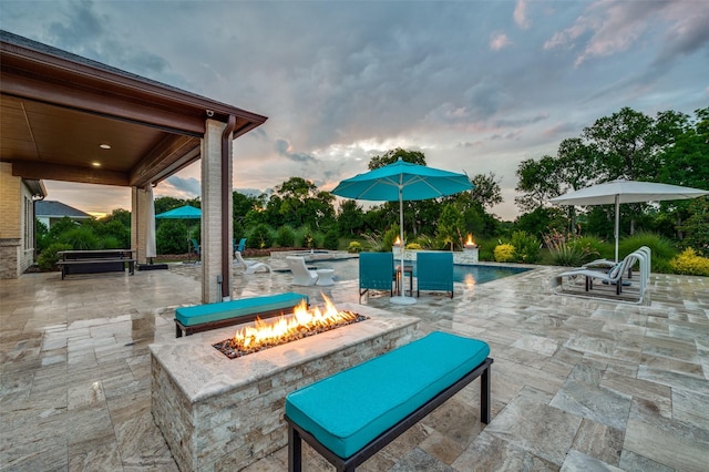 2110 Honey Ln, Celina, TX 75009 - patio terrace at dusk featuring a fire pit, a patio area, and an outdoor pool
