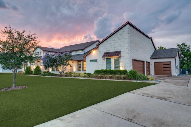 2110 Honey Ln, Celina, TX 75009 - contemporary home featuring a lawn, driveway, an attached garage, and stone siding
