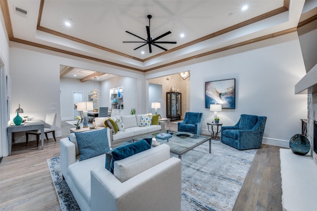 2110 Honey Ln, Celina, TX 75009 - living area with a tray ceiling, a ceiling fan, crown molding, light wood-type flooring, and recessed lighting