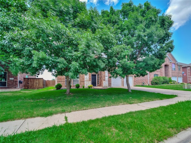 1034 Pelican Dr, Frisco, TX 75033 - view of property hidden behind natural elements with concrete driveway, brick siding, and a garage