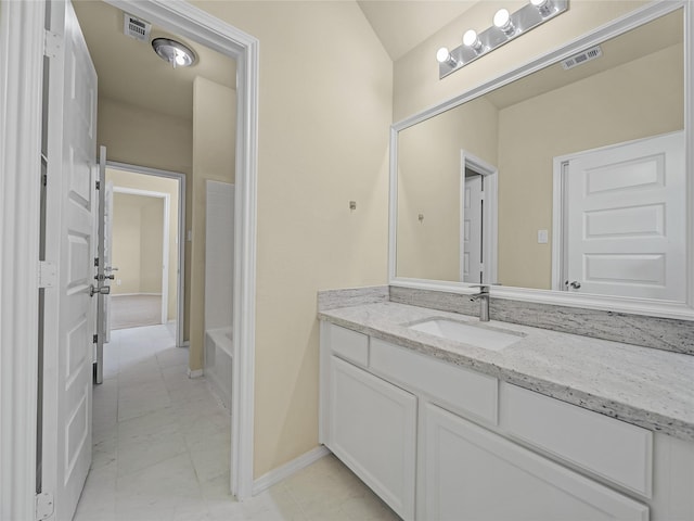 1034 Pelican Dr, Frisco, TX 75033 - full bathroom featuring vanity, a tub, marble finish flooring, and lofted ceiling