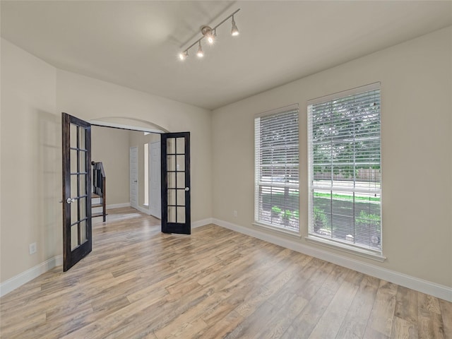 1034 Pelican Dr, Frisco, TX 75033 - spare room featuring french doors and light wood-style flooring