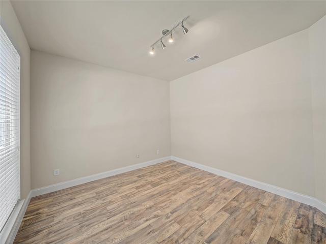1034 Pelican Dr, Frisco, TX 75033 - empty room with light wood-style flooring and track lighting