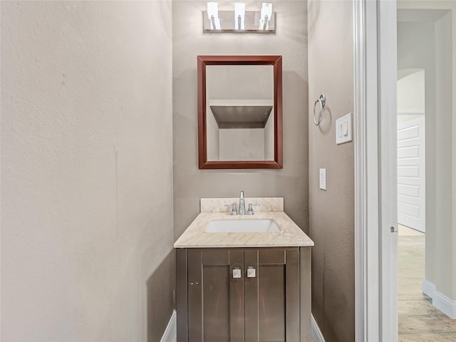 1034 Pelican Dr, Frisco, TX 75033 - bathroom with vanity, wood finished floors, and a textured wall