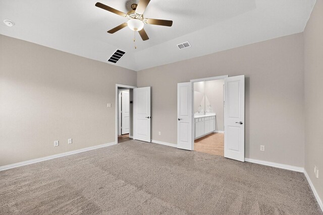 333 Edmund Ln, Fate, TX 75087 - unfurnished bedroom with light colored carpet, ensuite bathroom, a towering ceiling, and ceiling fan