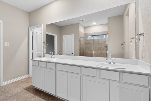 333 Edmund Ln, Fate, TX 75087 - full bathroom featuring double vanity, a stall shower, and tile patterned floors