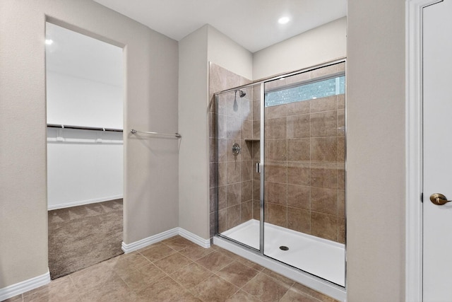 333 Edmund Ln, Fate, TX 75087 - full bath featuring a shower stall, a walk in closet, and tile patterned flooring