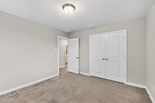 333 Edmund Ln, Fate, TX 75087 - unfurnished bedroom with carpet floors, a closet, and a textured ceiling