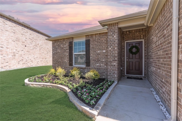 1105 Trace Dr, Aubrey, TX 76227 - exterior entry at dusk with brick siding and a lawn