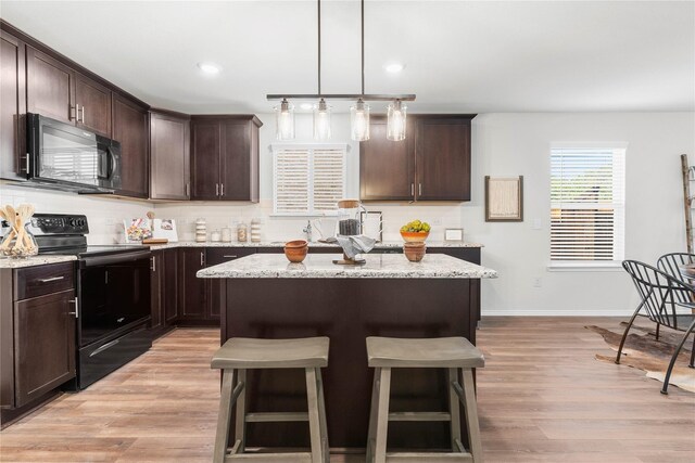 1105 Trace Dr, Aubrey, TX 76227 - kitchen with black appliances, dark brown cabinetry, a breakfast bar area, decorative backsplash, and recessed lighting