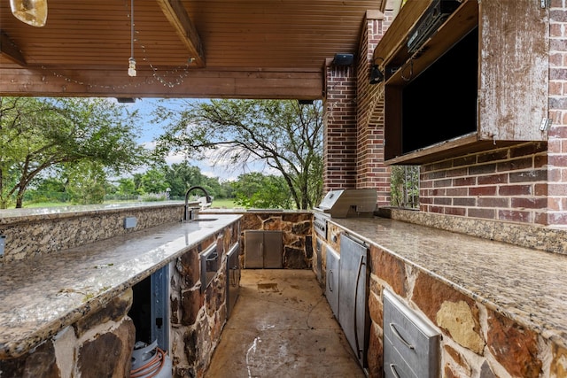 805 S Duncan Creek Ct, Weatherford, TX 76087 - view of patio with a sink and an outdoor kitchen