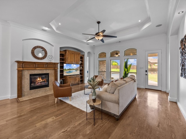 3241 Mindy Ln, Midlothian, TX 76065 - living area featuring a tray ceiling, a high end fireplace, wood finished floors, ornamental molding, and a ceiling fan