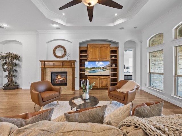 3241 Mindy Ln, Midlothian, TX 76065 - living area featuring a ceiling fan, a tray ceiling, a high end fireplace, light wood finished floors, and ornamental molding