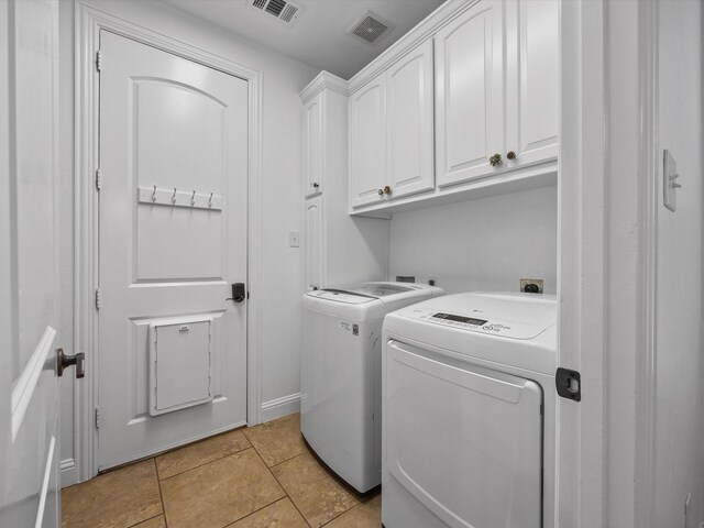 3241 Mindy Ln, Midlothian, TX 76065 - laundry area featuring cabinet space, washer and dryer, and light tile patterned flooring