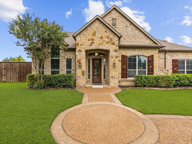 3241 Mindy Ln, Midlothian, TX 76065 - french country inspired facade featuring stone siding, roof with shingles, and brick siding