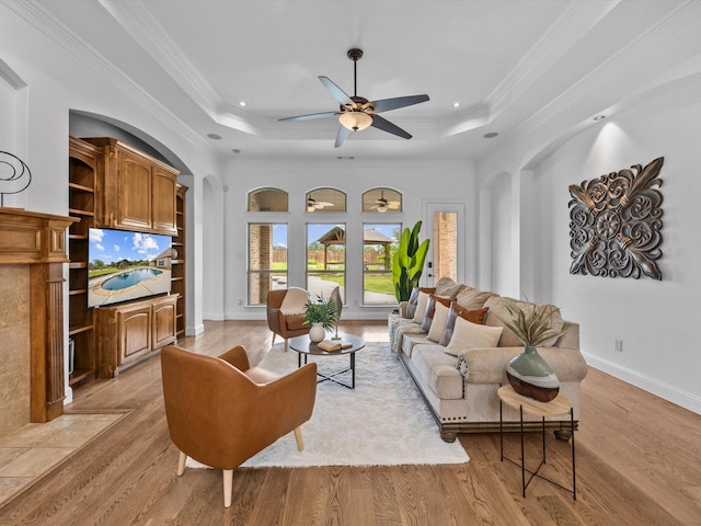 3241 Mindy Ln, Midlothian, TX 76065 - living room with a tray ceiling, a ceiling fan, light wood-type flooring, and ornamental molding