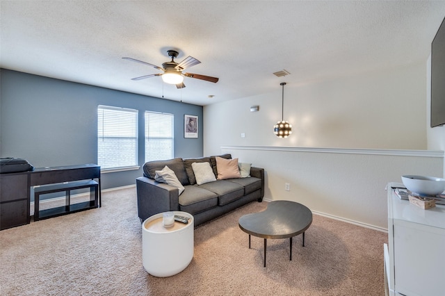 6318 White Oaks Ln, Frisco, TX 75035 - living room with carpet, a ceiling fan, a textured ceiling, and a chandelier