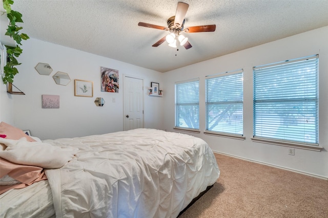 6318 White Oaks Ln, Frisco, TX 75035 - carpeted bedroom featuring a textured ceiling and a ceiling fan