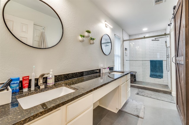 6318 White Oaks Ln, Frisco, TX 75035 - full bathroom featuring double vanity, a stall shower, tile patterned floors, and a textured wall