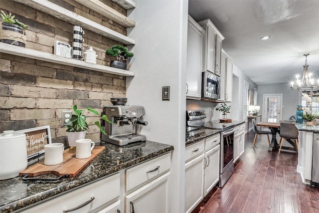 759 Bancroft Rd, Keller, TX 76248 - kitchen with appliances with stainless steel finishes, open shelves, a chandelier, dark wood-style flooring, and dark stone counters