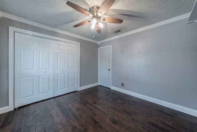 1825 Emerald Dr, Irving, TX 75060 - unfurnished bedroom with dark wood-style flooring, a textured ceiling, a closet, ceiling fan, and ornamental molding