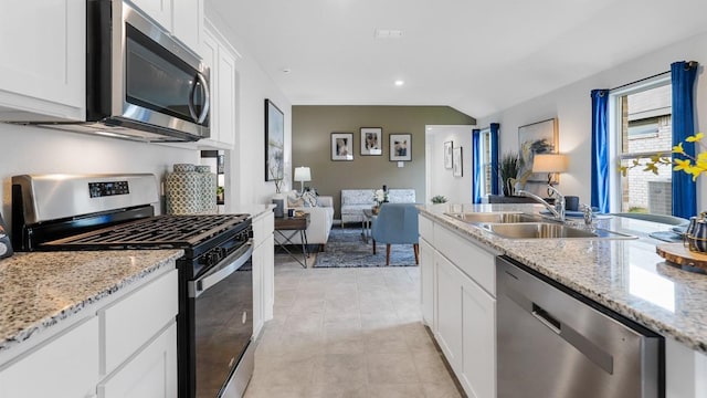 139 Gerber Ln, Boyd, TX 76023 - kitchen featuring stainless steel appliances, white cabinetry, recessed lighting, light stone counters, and open floor plan